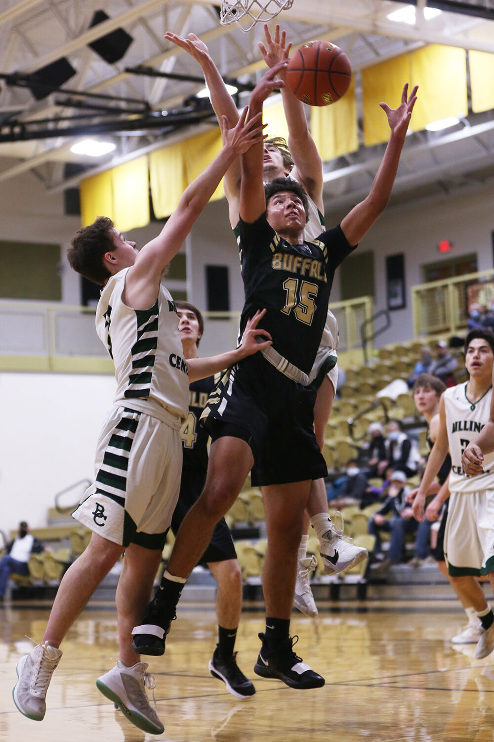 Eli Patterson stretches for a rebound so the Bison can shoot again